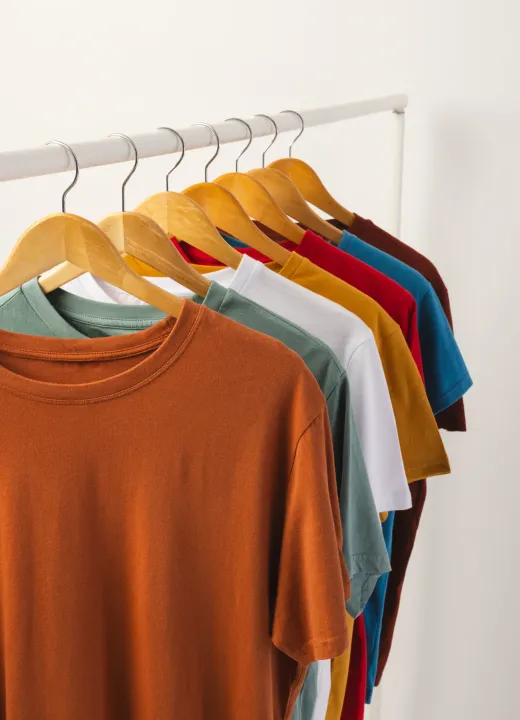 colorful-t-shirts-hanging-on-wooden-hangers